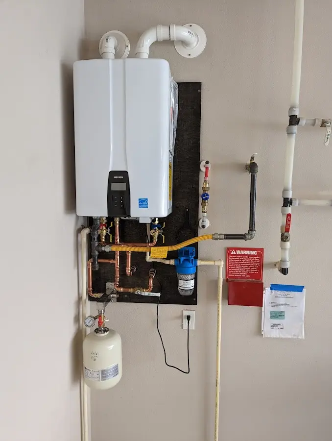 Professional plumber installing copper piping in a Silvis home